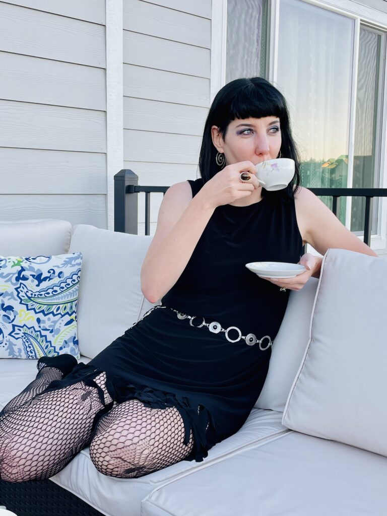 Woman drinking tea an an outdoor patio setting